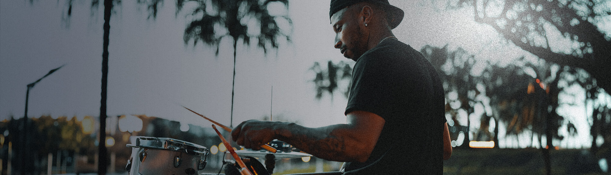 Man playing the drums outside