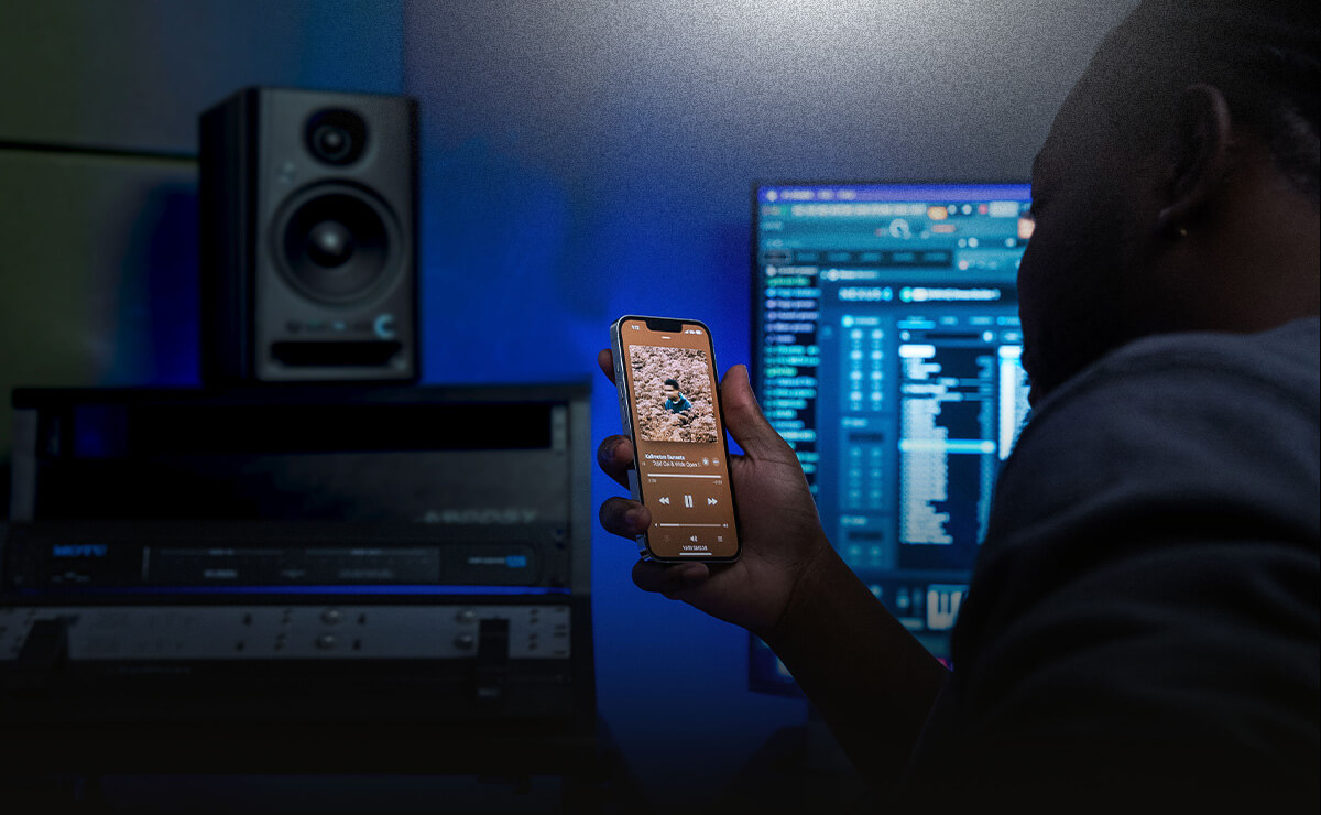 Man connecting his phone via Bluetooth to a Harbinger SM505 Studio Monitor