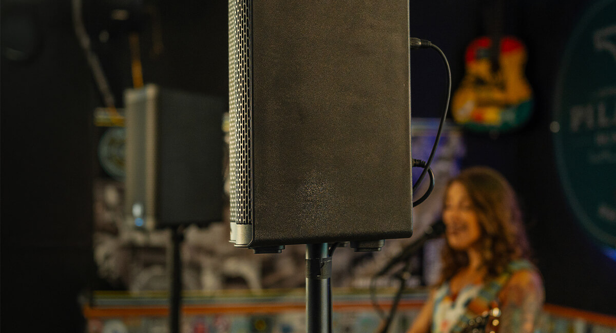 Two Harbinger Vari 2400 speakers linked inside small concert venue