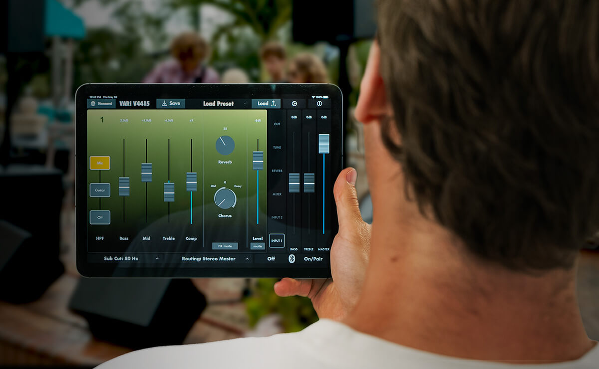 Man holding an ipad showing the Harbinger Vari App mixer controls