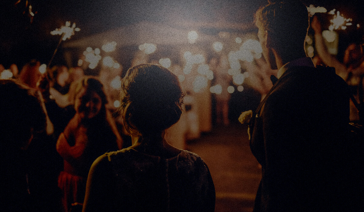 Bride and groom walking through sparklers