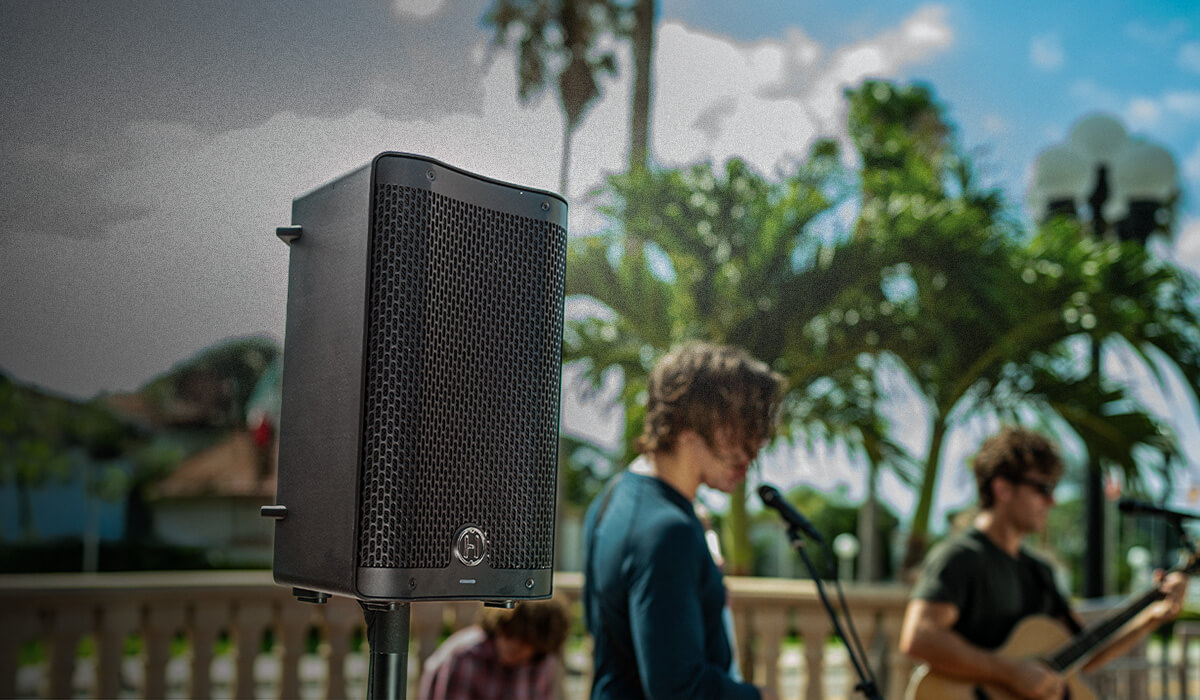 One Harbinger Vari Live V2400 Speaker on a pole at an outdoor concert