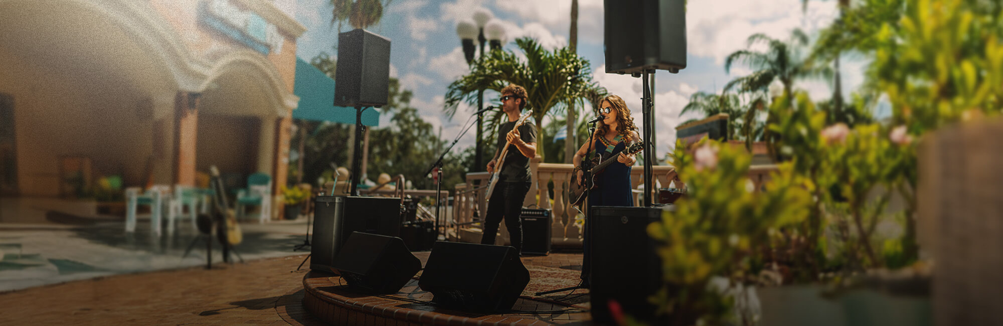 Harbinger Vari Speakers and Subs set up on outdoor stage with a live band